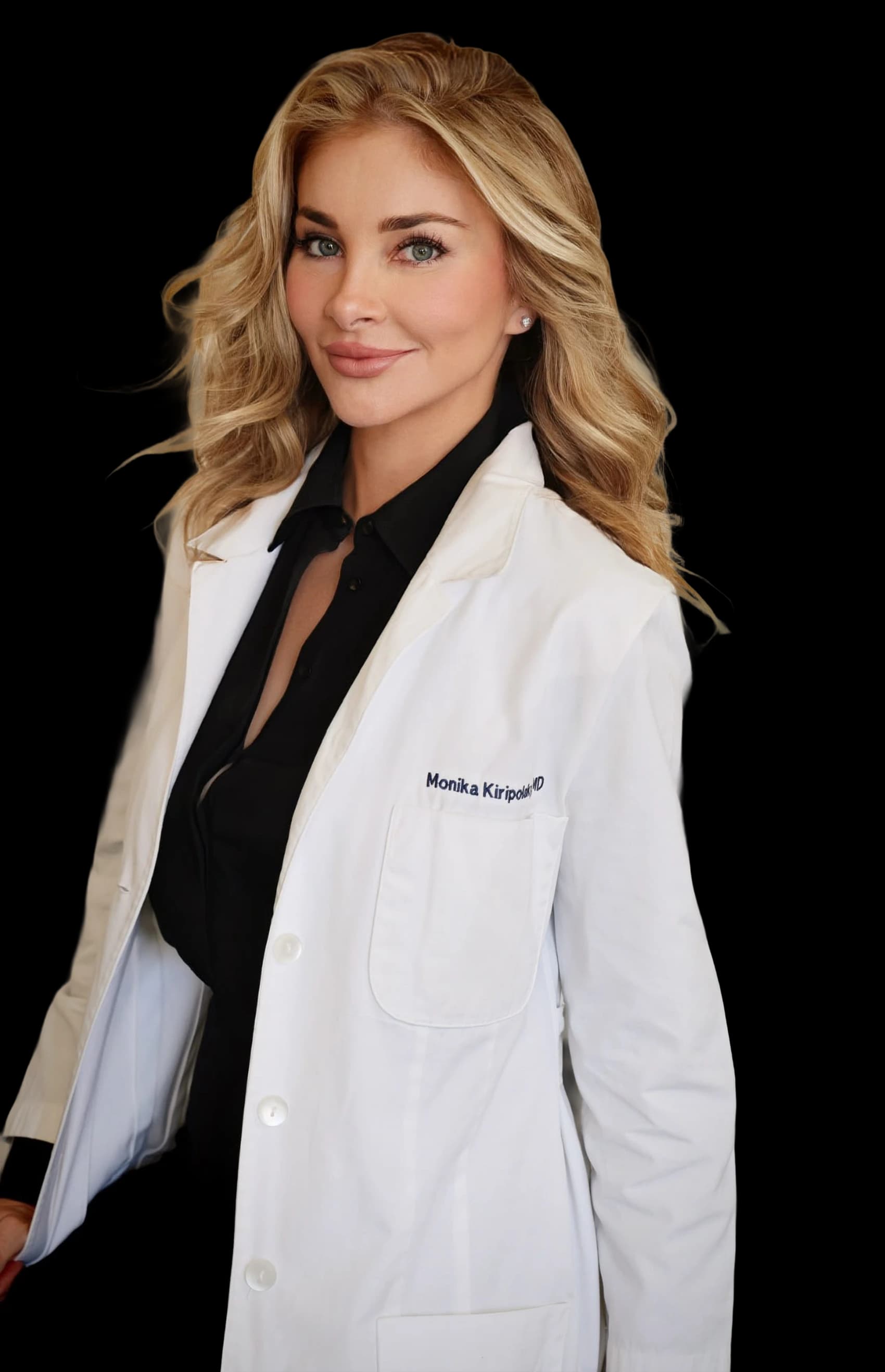 Dr. Monika Kiripolsky, board-certified dermatologist, in her white coat