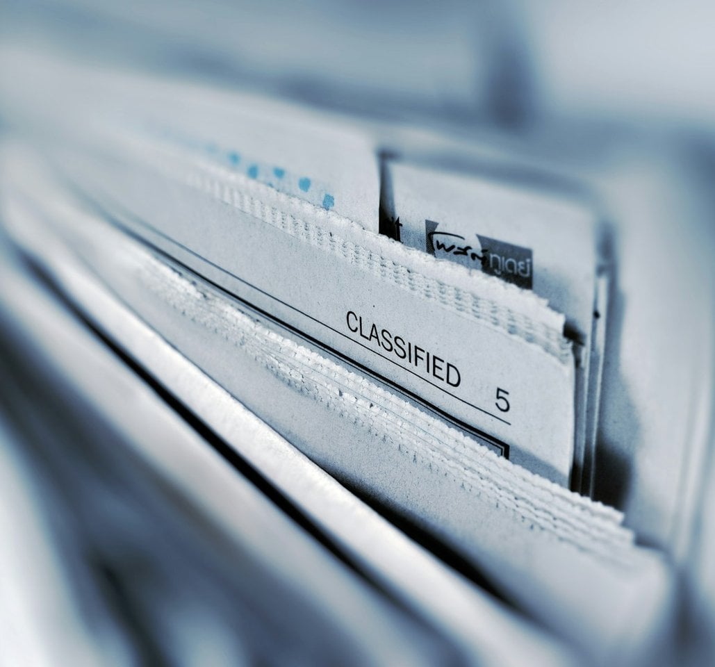 Newspapers fanned out on a desk
