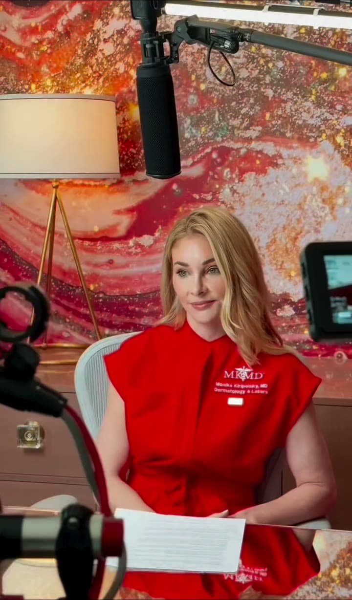 Dr. Monika Kiripolsky in her red MKMD scrubs on a television interview set